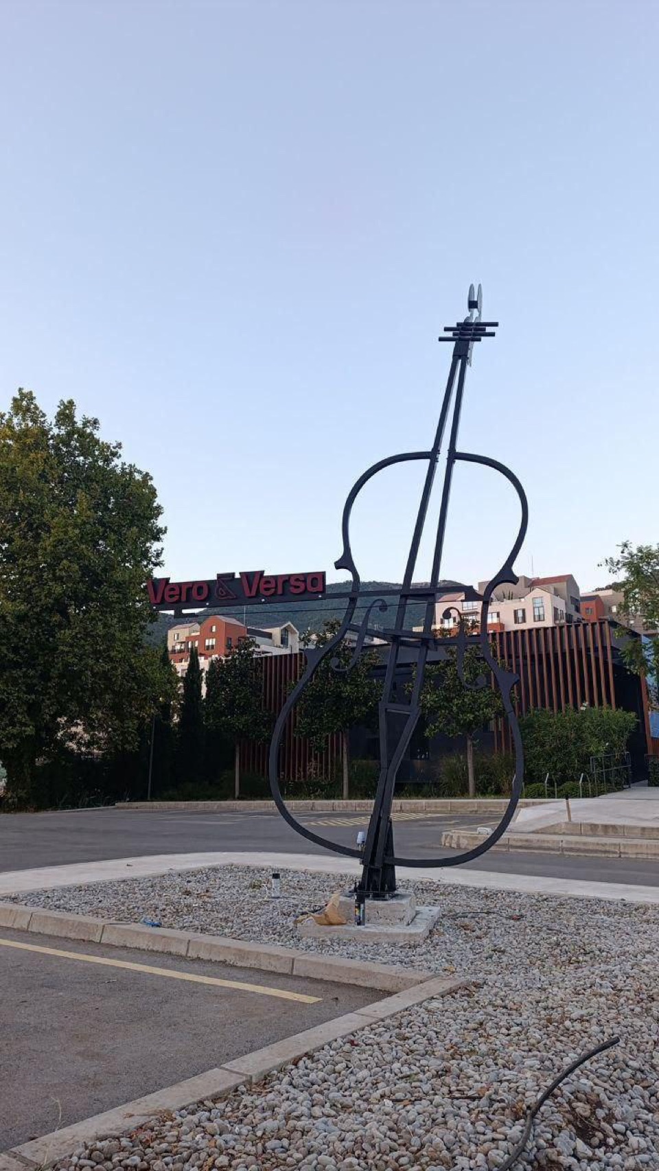 Finished steel violin-shaped art object in place