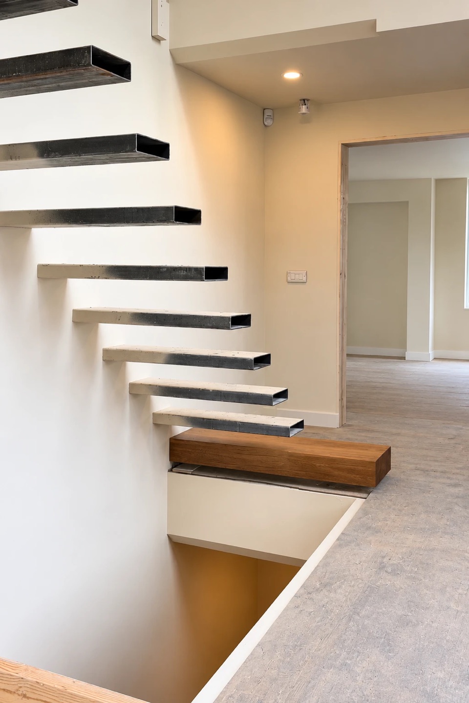 Steel box-section cantilevers fixed into the wall before the treads are fitted